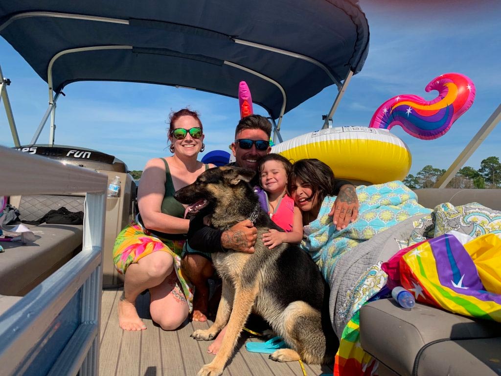 Family With Their Dog Having A Wonderful Experience With Their Rented Pontoon Boat